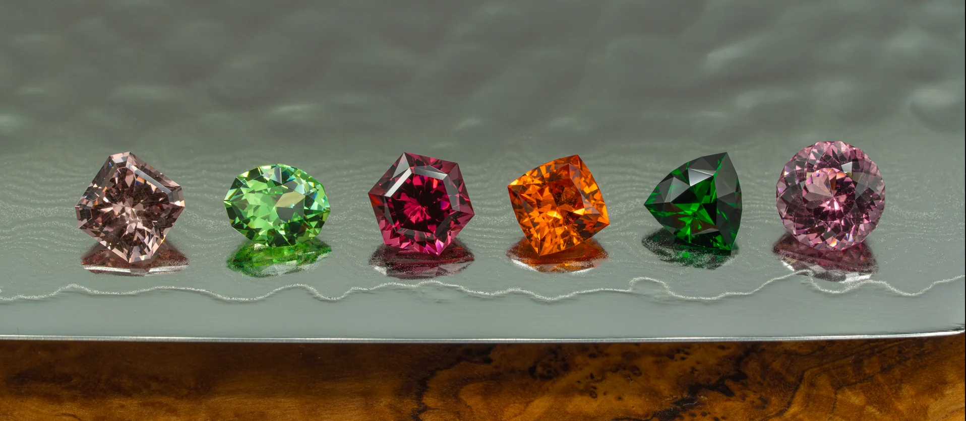 A curated selection of gemstones resting on a Japanese Nakiri knife
